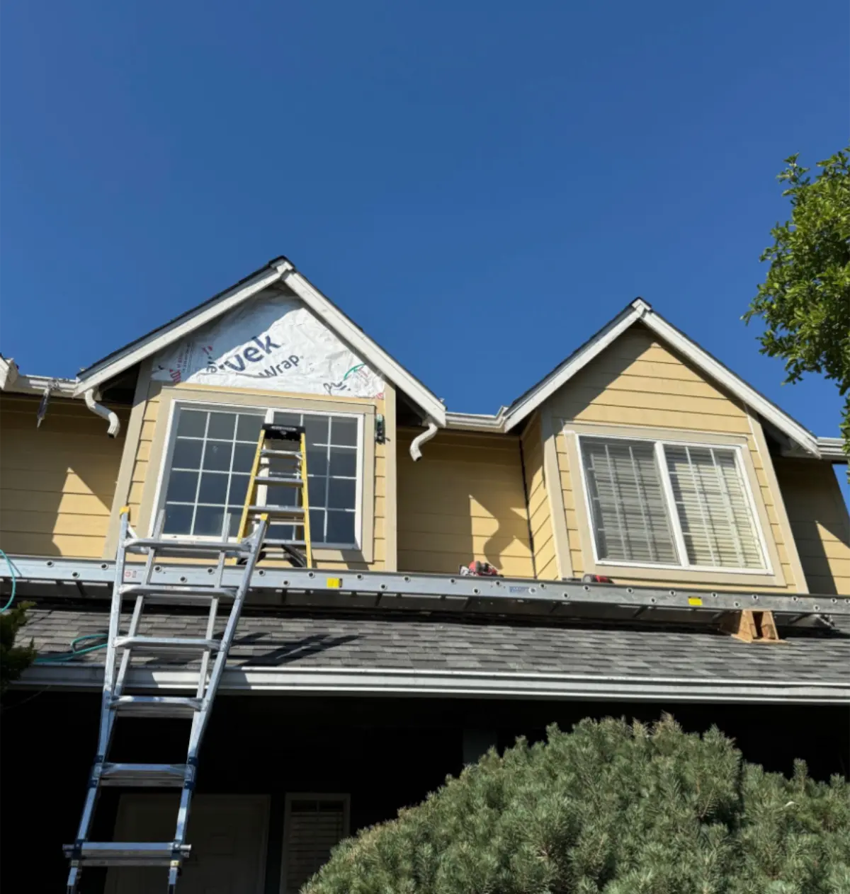 Close-up front view of gabled roofline with ladder