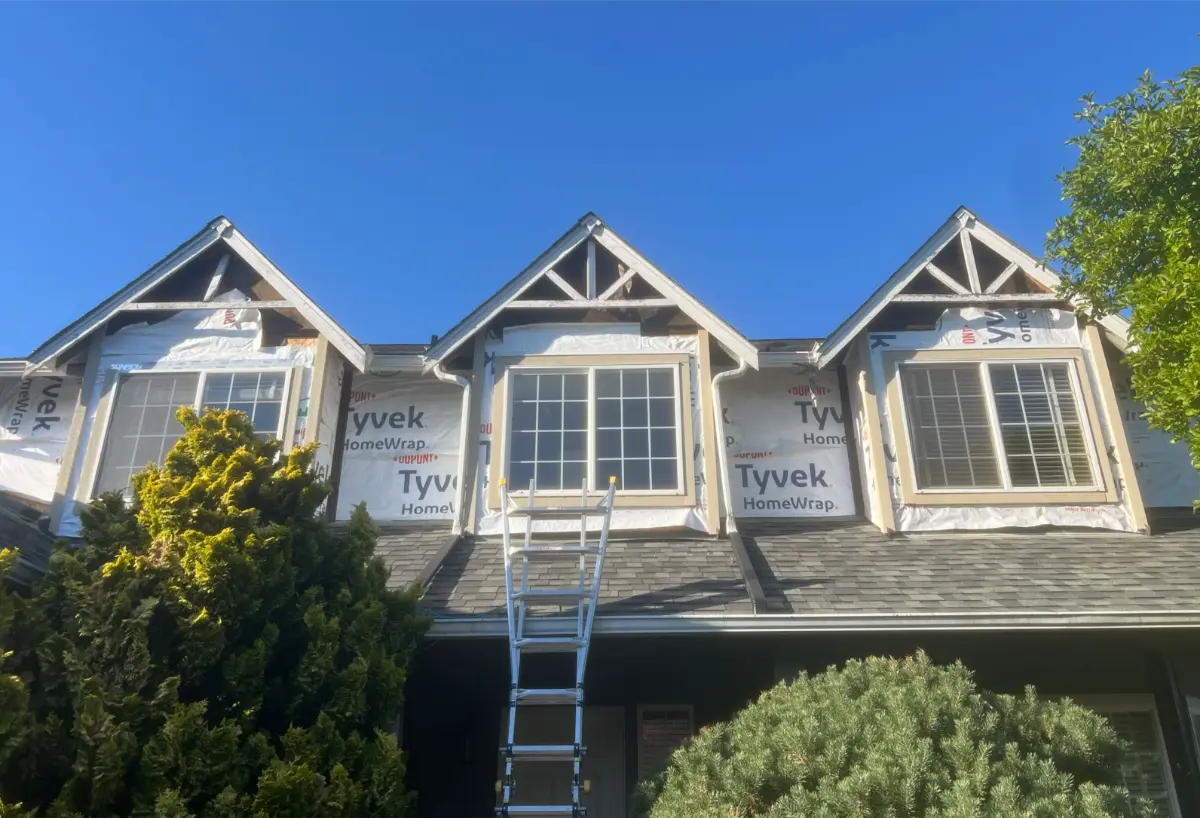 Front view of home with triple gable roofline