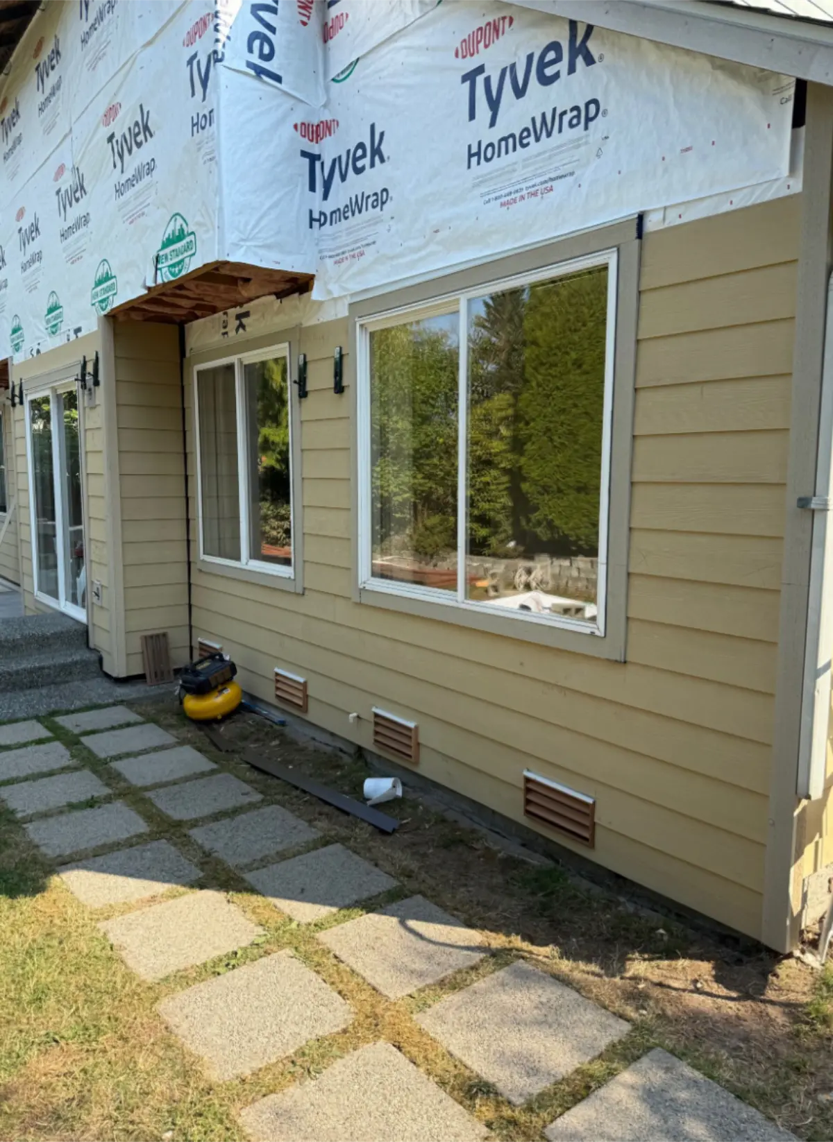 House wrap installed at corner near window before siding