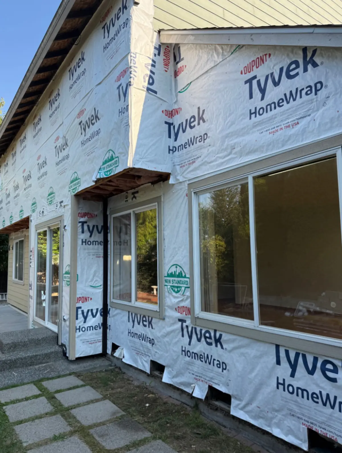 Tyvek house wrap installed around entry door and windows